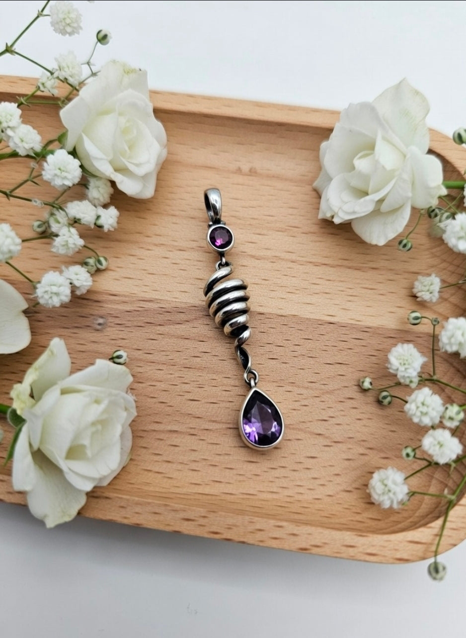 Spiral" pendant with amethyst and corundum